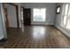 Spacious living room with hardwood floors and natural light from large windows at 4925 E New York St, Indianapolis, IN 46201
