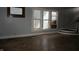 Open living room showcasing hardwood floors and staircase at 4925 E New York St, Indianapolis, IN 46201