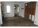 View of room with hardwood floors needing repair and paneled wall detail at 4925 E New York St, Indianapolis, IN 46201