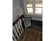 Staircase with black handrail and white pickets near a window at 4925 E New York St, Indianapolis, IN 46201