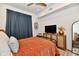 Well-lit bedroom with a ceiling fan and sleek TV, offering a relaxing atmosphere at 504 N Park Ave # 3, Indianapolis, IN 46202