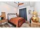 Cozy bedroom with modern ceiling fan, a metal frame bed, and wood-look flooring at 504 N Park Ave # 3, Indianapolis, IN 46202