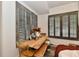 Rustic dining table surrounded by windows with stylish shutters, creating a cozy atmosphere at 504 N Park Ave # 3, Indianapolis, IN 46202