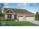 Charming brick home featuring a three-car garage, covered entryway, and manicured lawn at 5072 Astor Way, McCordsville, IN 46055