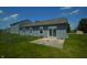 Spacious backyard with patio, surrounded by lush greenery and chainlink fencing, offering a private outdoor retreat at 5406 Shamus Dr, Indianapolis, IN 46235