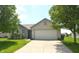 Charming single-story home featuring a brick facade, well-maintained lawn, and a two-car garage at 5406 Shamus Dr, Indianapolis, IN 46235