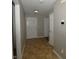 Hallway featuring neutral paint, tile floors, and doors leading to other rooms in the home at 5406 Shamus Dr, Indianapolis, IN 46235