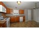 Bright kitchen features oak cabinets, tile floors, and ample countertop space at 5406 Shamus Dr, Indianapolis, IN 46235