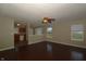 Open-concept living room with ceiling fan, wood floors, and natural light at 5406 Shamus Dr, Indianapolis, IN 46235