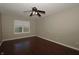 Spacious bedroom with wood floors, natural light, and ceiling fan at 5406 Shamus Dr, Indianapolis, IN 46235