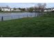 View of a spacious backyard with a serene pond and a fenced perimeter at 561 Prince Dr, Greenwood, IN 46142