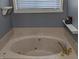 Relaxing bathroom featuring a large soaking tub and stylish fixtures, perfect for unwinding after a long day at 561 Prince Dr, Greenwood, IN 46142