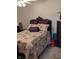 Traditional bedroom with floral bedding, patterned pillows, and a vintage dresser at 561 Prince Dr, Greenwood, IN 46142