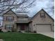 Charming two-story brick home with an attached two-car garage and well-maintained lawn at 561 Prince Dr, Greenwood, IN 46142