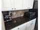 Kitchen counter and cabinets featuring granite countertops and modern backsplash at 561 Prince Dr, Greenwood, IN 46142