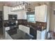 Bright kitchen featuring white cabinetry, granite countertops and modern light fixture at 561 Prince Dr, Greenwood, IN 46142