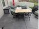 Outdoor patio with covered furniture, table, chairs, and gray concrete flooring at 561 Prince Dr, Greenwood, IN 46142