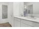 Bright bathroom featuring double sinks with a quartz countertop and modern fixtures at 5809 Sunstone Rd, Indianapolis, IN 46239
