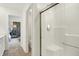 Bright bathroom with a glass-enclosed shower and neutral tile flooring at 5809 Sunstone Rd, Indianapolis, IN 46239