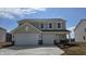 Two-story home featuring a two-car garage, neutral siding, and well-manicured front yard at 5809 Sunstone Rd, Indianapolis, IN 46239