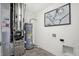 Functional utility room featuring a water heater, modern appliances, and neutral decor at 5809 Sunstone Rd, Indianapolis, IN 46239