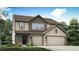 Charming two-story home with beige siding, brick accents, attached garage, and manicured lawn at 5846 Sunstone Rd, Indianapolis, IN 46239