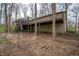 Exterior of the home with a stone facade and large deck overlooking the wooded backyard at 5918 Camelback Ct, Indianapolis, IN 46250