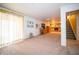 Finished basement with beige carpet, stairs, and a brick fireplace with yellow curtains at 5918 Camelback Ct, Indianapolis, IN 46250