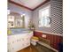 Unique bathroom featuring patterned wallpaper, a stained-glass window, and ornate mirror at 5918 Camelback Ct, Indianapolis, IN 46250