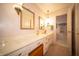 Bathroom featuring white marble countertops, vanity, and decorative lighting at 5918 Camelback Ct, Indianapolis, IN 46250