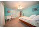 Bedroom featuring light blue walls, carpet, and a wooden bed frame with a white quilt at 5918 Camelback Ct, Indianapolis, IN 46250