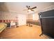 Nicely finished bedroom featuring a ceiling fan and gym equipment at 5918 Camelback Ct, Indianapolis, IN 46250