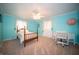 Bedroom with light blue walls, carpeted floor, wood-frame bed, and white desk area at 5918 Camelback Ct, Indianapolis, IN 46250