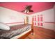 Bright bedroom featuring wood floors, ceiling fan, and unique designs at 5918 Camelback Ct, Indianapolis, IN 46250