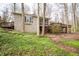 View of a beautiful home with a stone exterior and a wooden deck overlooking the lawn at 5918 Camelback Ct, Indianapolis, IN 46250