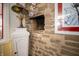 Close-up of a unique stone fireplace with small display shelf and decorations at 5918 Camelback Ct, Indianapolis, IN 46250