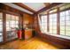 Cozy living room with dark wood paneling, hardwood floors, and a bay window at 5918 Camelback Ct, Indianapolis, IN 46250