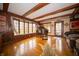 Living room featuring hardwood floors, wood paneling, and a large bay window next to a grand piano at 5918 Camelback Ct, Indianapolis, IN 46250