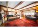 Elegant living room with stained-glass windows, exposed ceiling beams, and a plush area rug at 5918 Camelback Ct, Indianapolis, IN 46250