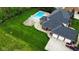 Expansive backyard with in-ground pool, patio, three car garage, and lush green lawn at 633 Foxboro Dr, Avon, IN 46123