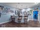 Basement bar with seating for three, blue walls, and custom decor at 633 Foxboro Dr, Avon, IN 46123