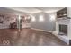 Finished basement showcasing wood floors, a white brick fireplace, and an open bar area at 633 Foxboro Dr, Avon, IN 46123