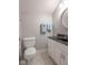 Bathroom with a gray wall, a toilet, and a vanity with black countertop and white cabinets at 633 Foxboro Dr, Avon, IN 46123