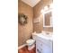 Cozy half bathroom features white vanity, toilet, textured wallpaper, and hardwood floors at 633 Foxboro Dr, Avon, IN 46123