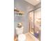 Bathroom featuring a toilet, glass shower, and decorative shelving unit at 633 Foxboro Dr, Avon, IN 46123