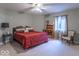 Spacious bedroom featuring a comfortable queen-size bed, ceiling fan, and a cozy reading corner at 633 Foxboro Dr, Avon, IN 46123