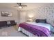 Bedroom with carpet, a bed with a white comforter and purple blanket, plus a sitting area at 633 Foxboro Dr, Avon, IN 46123