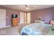 Bedroom featuring soft mauve walls, carpet, and a queen bed with patterned bedding at 633 Foxboro Dr, Avon, IN 46123