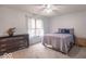 Bedroom with neutral tones, window, and ceiling fan, offering a tranquil retreat at 633 Foxboro Dr, Avon, IN 46123
