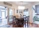 Casual dining area with modern lighting, hardwood floors, and access to the sunroom at 633 Foxboro Dr, Avon, IN 46123